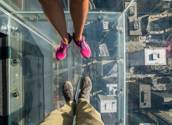 people looking down through the sky deck in Chicago, IL