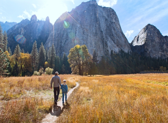 father and son walking el Capitan at Yosemite National Park