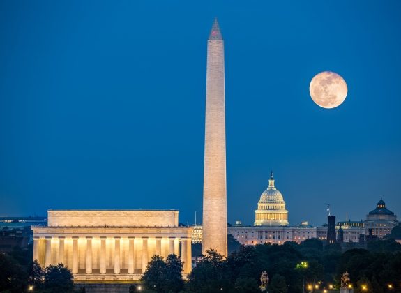 Supermoon above three iconic monuments: Lincoln Memorial, Washington Monument and Capitol Building in Washington DC as viewed from Arlington, Virginia