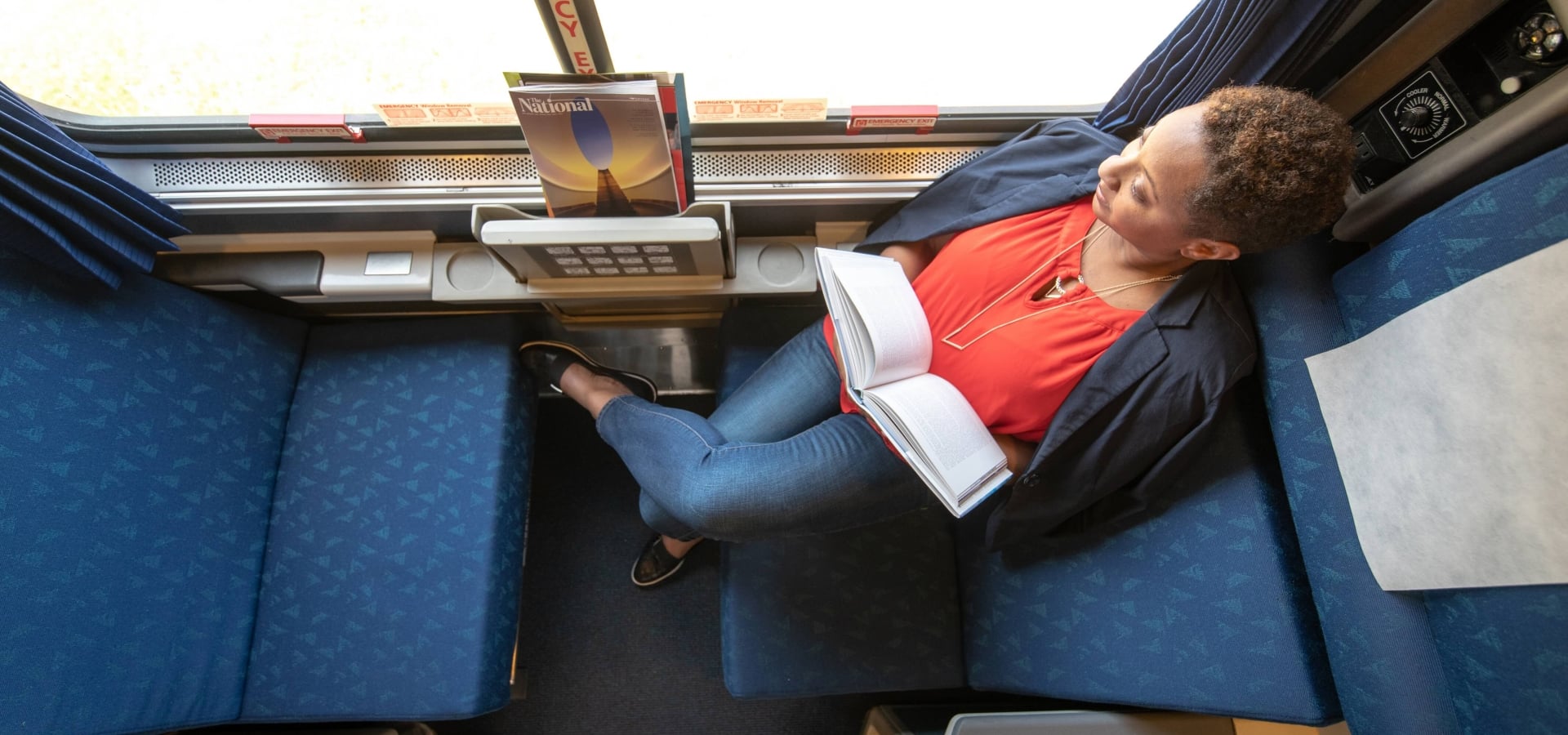 woman reading book in a roomette onboard amtrak