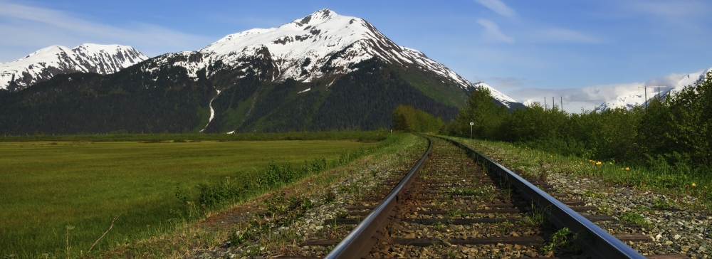 railroad tracks in Alaska by mountain view